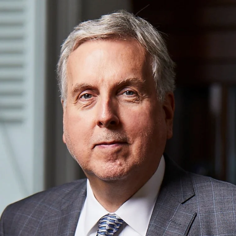 Man in suit smiling.